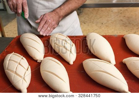 Cut Into The Bread Of The Already Fermented Bread Before It Goes Into The Oven