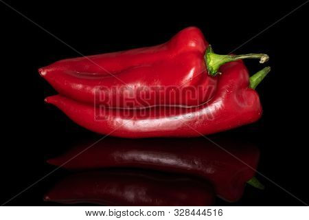 Group Of Two Whole Sweet Red Bell Pepper Isolated On Black Glass