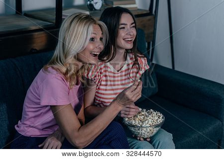 Exticed Mother And Daughter Watching Tv And Eating Popcorn