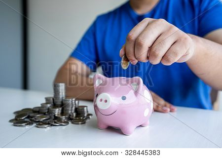 Man Putting Coins To Planning Growing Saving To Strategy With Piggy Bank For Future Plan Fund Of Tra