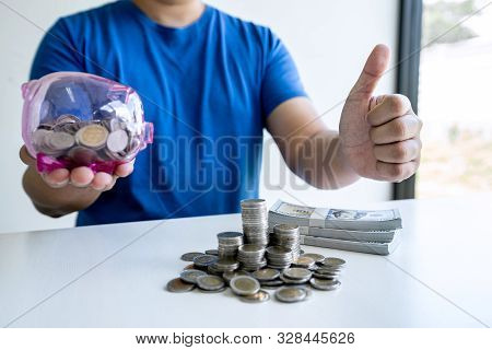 Man Putting Coins To Planning Growing Saving To Strategy With Piggy Bank For Future Plan Fund Of Tra