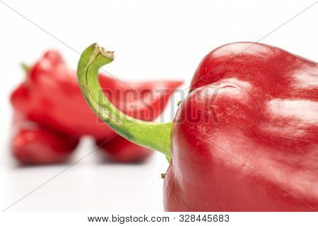 Group Of Four Whole Sweet Red Bell Pepper Isolated On White Background