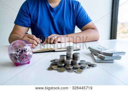 Man Putting Coins To Planning Growing Saving To Strategy With Piggy Bank For Future Plan Fund Of Tra
