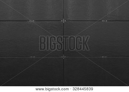 Black Unsmooth Surface Of Building Wall With Connected Tiles