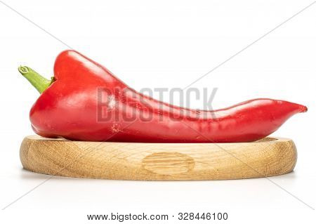 One Whole Sweet Red Bell Pepper On Bamboo Plate Isolated On White Background