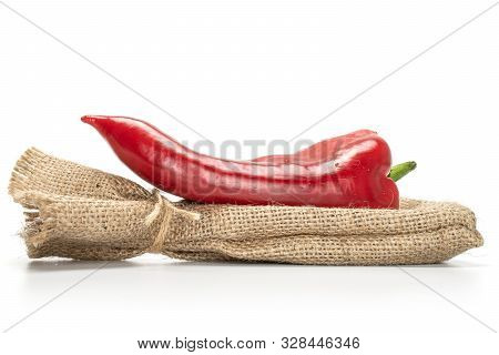 One Whole Sweet Red Bell Pepper With Jute Bag Isolated On White Background