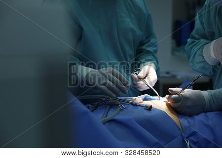 Medical Team Performing Surgery In Operating Room, Closeup