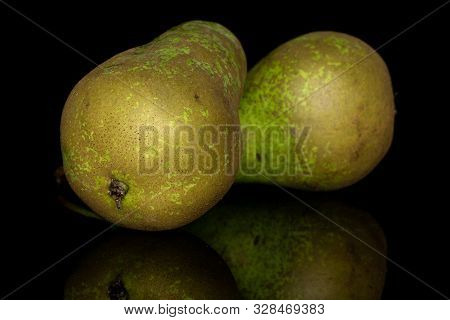 Group Of Two Whole Fresh Green Pear Isolated On Black Glass