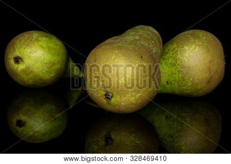 Group Of Three Whole Fresh Green Pear Isolated On Black Glass