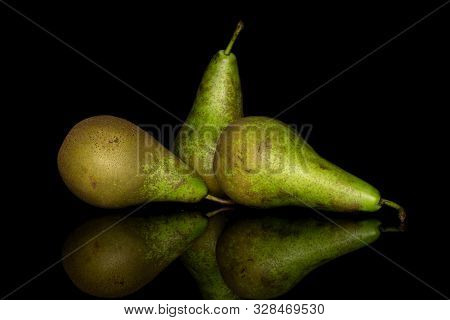 Group Of Three Whole Fresh Green Pear Isolated On Black Glass