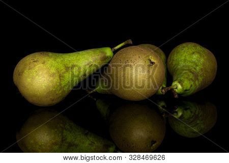 Group Of Three Whole Fresh Green Pear Isolated On Black Glass