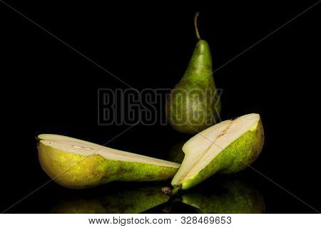 Group Of One Whole Two Halves Of Fresh Green Pear Isolated On Black Glass
