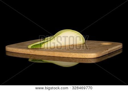 Group Of Three Slices Of Fresh Green Pear On Bamboo Cutting Board Isolated On Black Glass