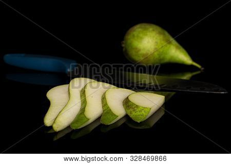 Group Of One Whole Five Slices Of Fresh Green Pear With Steel Knife Isolated On Black Glass