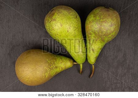 Group Of Three Whole Fresh Green Pear Flatlay On Grey Stone