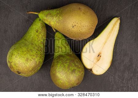 Group Of Three Whole One Half Of Fresh Green Pear Flatlay On Grey Stone