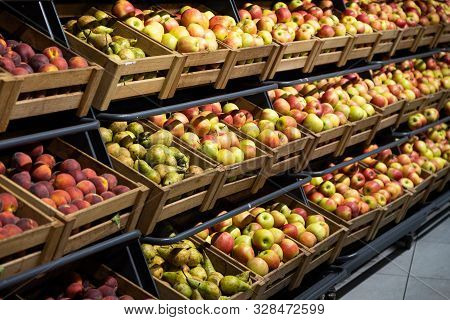 Supermarket Counter With Wooden Lug Boxes Full With Fruit: Apples, Pears And Peaches. Photo With Dep