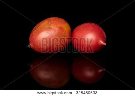 Group Of Two Whole Fresh Tomato De Barao Isolated On Black Glass
