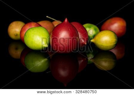 Group Of Ten Whole Fresh Tomato De Barao Isolated On Black Glass