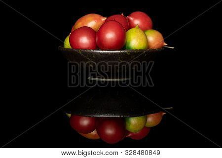 Lot Of Whole Fresh Tomato De Barao On Glazed Bowl Isolated On Black Glass