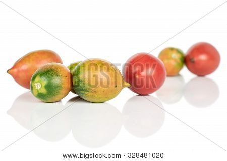 Group Of Seven Whole Fresh Tomato De Barao Isolated On White Background