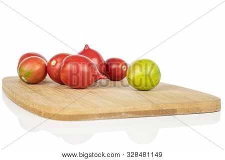 Lot Of Whole Bright Fresh Tomato De Barao On Bamboo Cutting Board Isolated On White Background