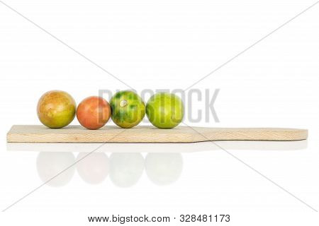 Group Of Four Whole Fresh Tomato De Barao On Wooden Cutting Board Isolated On White Background