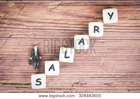 Payroll And Salaries Ladder Increase Growth Money Coins On Table And Success Concept / Salary Text B
