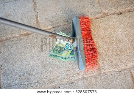 Housekeeping Broom Sweeping Hundredth Euro Banknote On Street. Money Or Business Concept