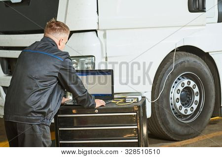 Truck repair service. Mechanic makes computer diagnostic of the semitruck