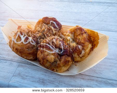 Takoyaki - A Japanese Snack Of Savory Ball-shaped Cake Made From Wheat Batter Cooked On A Specially 