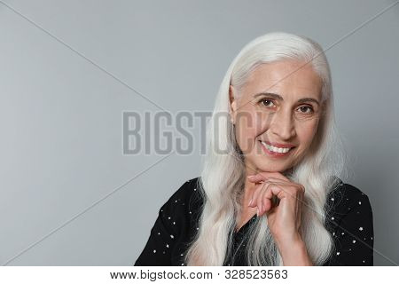 Portrait Of Beautiful Mature Woman On Grey Background, Space For Text