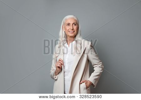 Portrait Of Beautiful Mature Woman On Grey Background