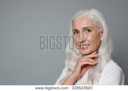 Portrait Of Beautiful Mature Woman On Grey Background, Space For Text
