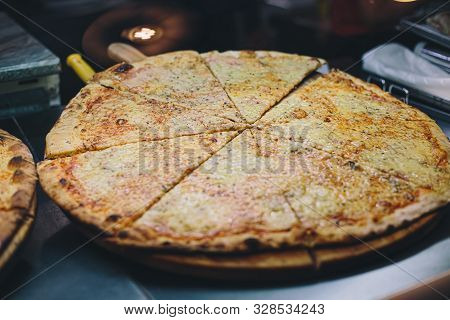 Hot Pizza Displayed For Sale Inside Display Case In Street Restaurant