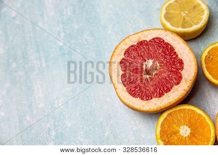 Bright Slices Of Oranges And Grapefruit On A Blue Background