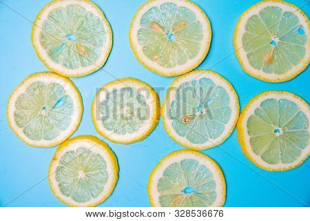 Slices Of Lemons On A Blue Background