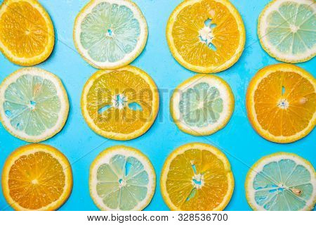 Slices Of Lemons And Oranges On A Blue Background