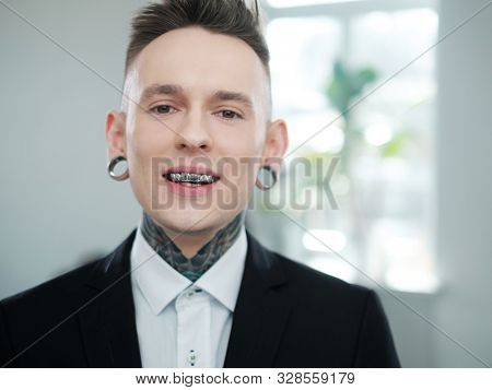 Portrait of alternative model with earplugs and tattoo