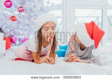 Little Sweettooth Siblings Tasting Delicious Candies, Enjoying The Moment, Isolated Over White New Y