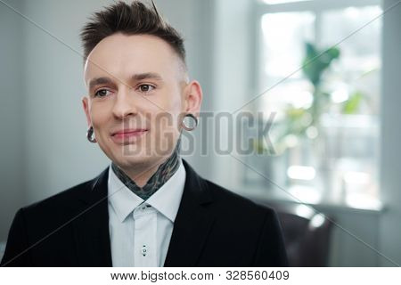 Portrait of alternative model with earplugs and tattoo