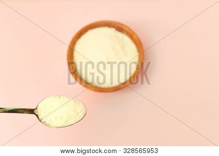 Collagen Protein In The Bowl And Spoon On Pink Background