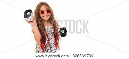 Smiling Little Girl Listenes To Music From Sterio Devices.