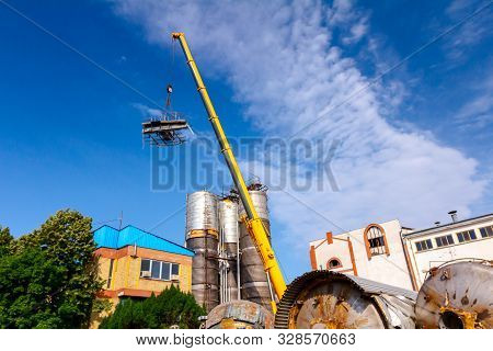 Crane Is Bringing Down Part Of Heavy Metal Construction In Industrial Complex.