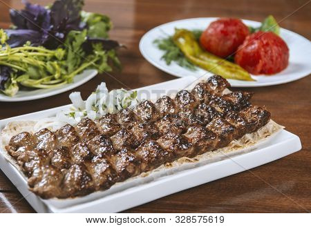 Fast food. Eastern food. Shish kebab, lyulya-kebab. Dishes of oriental cuisine lying in plte and dec