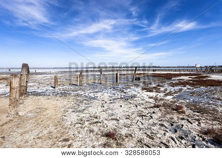 Salt Lake With Mud Baths. Treatment In A Salt Lake. Sanatorium. Wooden Posts For Salt Mining.