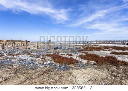 Salt Lake With Mud Baths. Treatment In A Salt Lake. Sanatorium. Wooden Posts For Salt Mining.