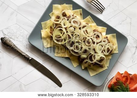 Beshbarmak Is A National Kazakh Dish - Square Pasta With Boiled Meat And Onions.