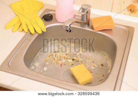 Close Up On Dirty Clogging Kitchen Sink Drain With Food Particles