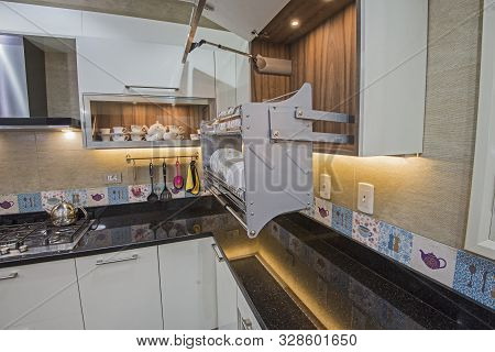 Interior Design Decor Showing Modern Kitchen With Swinging Cupboard In Luxury Apartment Showroom